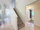 Home foyer with staircase leading to the second floor, and bathroom off the hallway at 1609 River Birch Ave, Oviedo, FL 32765