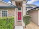 Close-up of front door, showcasing stone accents and manicured landscaping at 1609 River Birch Ave, Oviedo, FL 32765