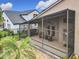 A view of the home's screened-in lanai and backyard at 1609 River Birch Ave, Oviedo, FL 32765