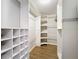 Spacious walk-in closet offers ample storage with custom shelving and laminate floors at 1609 River Birch Ave, Oviedo, FL 32765