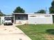 A well-maintained single-story home with a simple facade, a concrete driveway, and a lush green lawn at 1824 Dorris Dr, Orlando, FL 32807