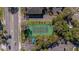 Aerial view of a tennis court surrounded by trees in a neighborhood at 200 Maitland Ave # 12, Altamonte Springs, FL 32701