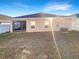 Fenced backyard featuring a screened porch and green grass at 2015 Sloans Outlook Dr, Groveland, FL 34736