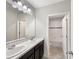 Bathroom featuring dual sinks, dark cabinets and a shower/tub combo at 2015 Sloans Outlook Dr, Groveland, FL 34736