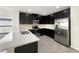 Modern kitchen featuring stainless steel appliances, white counters, and dark cabinets at 2015 Sloans Outlook Dr, Groveland, FL 34736