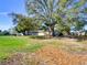 Expansive backyard with mature trees providing ample shade and privacy at 2055 Jessamine Ct, Deltona, FL 32738