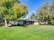 Rear exterior of home featuring a screened in porch and large grassy backyard at 2055 Jessamine Ct, Deltona, FL 32738