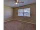 Neutral bedroom featuring carpet flooring, a ceiling fan, and a view of the neighborhood at 2055 Jessamine Ct, Deltona, FL 32738