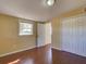 Bedroom features wood floors, a window view, and a double-door closet at 2055 Jessamine Ct, Deltona, FL 32738