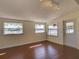 Bright bonus room with wood floors, two windows and a door to the outside at 2055 Jessamine Ct, Deltona, FL 32738