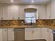 Well-lit kitchen featuring white cabinets, granite countertops, and stainless steel appliances at 2055 Jessamine Ct, Deltona, FL 32738