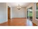 Dining room features hardwood floors, a chandelier, and sliding glass doors to the backyard at 2201 Coach House Blvd # 3, Orlando, FL 32812