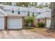 Charming townhome exterior featuring a brick facade, light siding, well-kept landscaping, and attached garage at 2201 Coach House Blvd # 3, Orlando, FL 32812