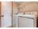 Laundry room with white washer and dryer set, and storage shelves above at 2201 Coach House Blvd # 3, Orlando, FL 32812