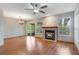 Spacious living room featuring a fireplace, ceiling fan, and sliding glass doors at 2201 Coach House Blvd # 3, Orlando, FL 32812