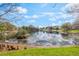 A view of the pond and surrounding community from the edge of the property at 2201 Coach House Blvd # 3, Orlando, FL 32812