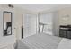 Bedroom featuring white closet doors, window with white blinds and a mirror at 2230 Cascades Blvd # 104, Kissimmee, FL 34741