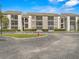 Condo complex with well maintained landscaping, ample parking and neutral exterior paint in a suburban setting at 2230 Cascades Blvd # 104, Kissimmee, FL 34741