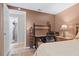 Bedroom featuring a desk area and a door leading to a bathroom with a tiled floor at 2260 Danforth Ave, Deltona, FL 32738