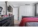 Well-lit bedroom featuring a large closet, dresser, and wall-mounted television for ultimate convenience at 2260 Danforth Ave, Deltona, FL 32738