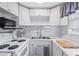 Bright kitchen featuring white cabinets, stainless steel sink and modern backsplash at 2260 Danforth Ave, Deltona, FL 32738