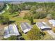 Aerial view of multiple homes surrounded by lush greenery and mature trees at 2706 Cranmoor Dr, Kissimmee, FL 34758