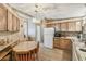 A bright eat-in kitchen with wood cabinets, white appliances, and a pendant light fixture at 2706 Cranmoor Dr, Kissimmee, FL 34758