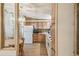 A view of kitchen and dining table through the doorway; wood cabinets and white appliances at 2706 Cranmoor Dr, Kissimmee, FL 34758