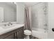 Bathroom featuring a tub with shower, modern vanity and mirror, with stylish grey accents at 2740 Courtland Blvd, Deltona, FL 32738