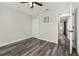 Bedroom with gray vinyl flooring, white trim, closet, and window views at 2740 Courtland Blvd, Deltona, FL 32738