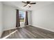 Bright bedroom with a ceiling fan, gray vinyl flooring, and a window with backyard views at 2740 Courtland Blvd, Deltona, FL 32738