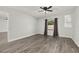 Bright bedroom featuring wood-look floors, a ceiling fan, and a window with curtains at 2740 Courtland Blvd, Deltona, FL 32738