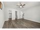 Bedroom with wood-look floors, and multiple closets, one leading to an adjacent bathroom at 2740 Courtland Blvd, Deltona, FL 32738