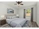 Relaxing bedroom featuring a tufted headboard, natural light, and wood-look flooring at 2740 Courtland Blvd, Deltona, FL 32738