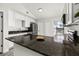 Granite counters top white cabinets in this kitchen with stainless appliances and a view to the backyard at 2740 Courtland Blvd, Deltona, FL 32738