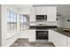 This bright kitchen has white cabinets, a stainless oven, and a view to the outdoors at 2740 Courtland Blvd, Deltona, FL 32738