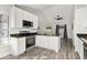 Bright kitchen with white cabinets, granite countertops and views into the living room at 2740 Courtland Blvd, Deltona, FL 32738