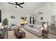 Open living room featuring wood-look flooring, a ceiling fan, and a sliding glass door to the backyard at 2740 Courtland Blvd, Deltona, FL 32738