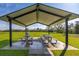 Covered picnic area with tables for outdoor dining, surrounded by green space at 2740 Courtland Blvd, Deltona, FL 32738