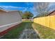 Side yard view featuring a wood fence and green grass, offering privacy and space at 2740 Courtland Blvd, Deltona, FL 32738