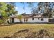 Backyard featuring a patio area and a spacious lawn, perfect for outdoor entertaining at 277 Sandpiper Dr, Casselberry, FL 32707