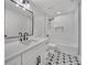 Renovated bathroom featuring a modern vanity with black hardware, tiled floors, and a shower-tub combo at 277 Sandpiper Dr, Casselberry, FL 32707