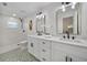 Bright bathroom featuring dual sinks, modern fixtures, and a walk-in shower with white subway tile at 277 Sandpiper Dr, Casselberry, FL 32707