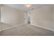 Bright, carpeted bedroom featuring neutral walls, a closet, and white trim at 277 Sandpiper Dr, Casselberry, FL 32707