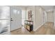 Well-lit foyer with decorative glass front door, stylish console table, and sleek laminate wood flooring at 277 Sandpiper Dr, Casselberry, FL 32707