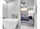 Modern bathroom featuring a soaking tub, white marble, and bedroom access at 2902 Egrets Landing Dr, Lake Mary, FL 32746