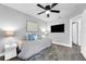 Well lit bedroom featuring a large window and a modern ceiling fan at 2902 Egrets Landing Dr, Lake Mary, FL 32746