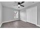 Bright bedroom with wood-look flooring, large closet, and a ceiling fan at 2902 Egrets Landing Dr, Lake Mary, FL 32746