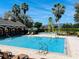 Large community pool with clear blue water, ample lounge chairs, and a covered pavilion at 2902 Egrets Landing Dr, Lake Mary, FL 32746