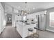 Modern kitchen featuring stainless steel appliances, white cabinets, and a marble island with seating at 2902 Egrets Landing Dr, Lake Mary, FL 32746